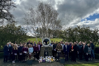 Everyone at IWMD 2024 event with the memorial and flowers