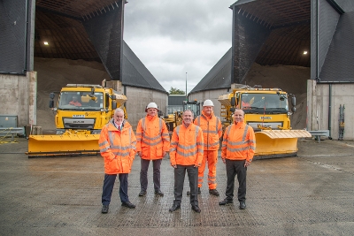 Cllr Conn and council staff with snow ploughs at salt domes