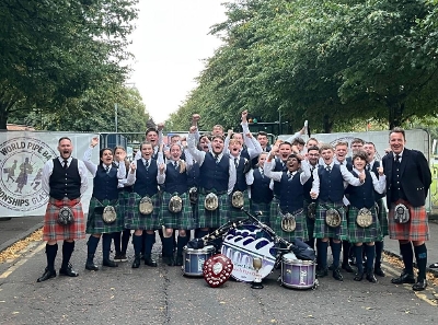 West Lothian Schools Pipe Band Worlds success Band members with their World Champions trophy.